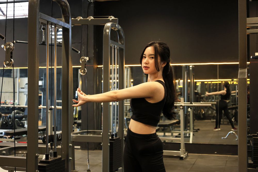 Young Woman Stretching at the Gym