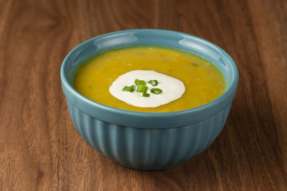 Bowl with pumpkin soup on the table.