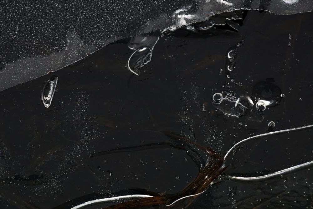 Fragment of thin ice on dark frozen river