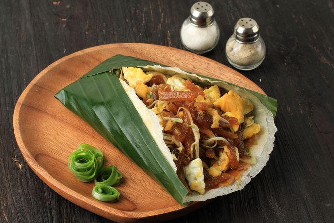 Banana leaf around steamed wrapped lumpia dish