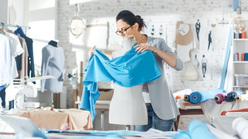 Female fashion, designer,  Adjusting Fabrics on a Tailored Mannequin.