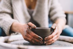 Crop potter shaping vessel on wheel