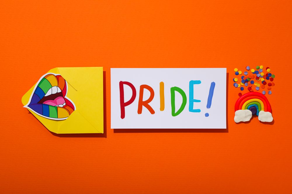 Pride parade concept, symbols on orange background.