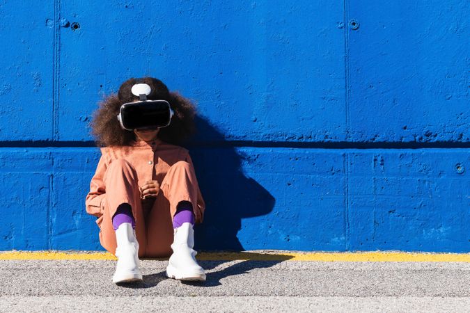 Black teenager in VR headset exploring cyberspace