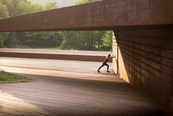 young woman stretching leaning in a amazing geometrical building