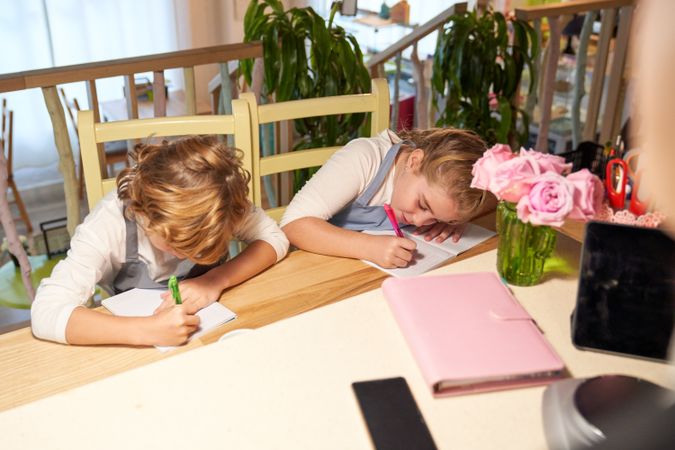 Concentrated boy and girl doing exercises at school