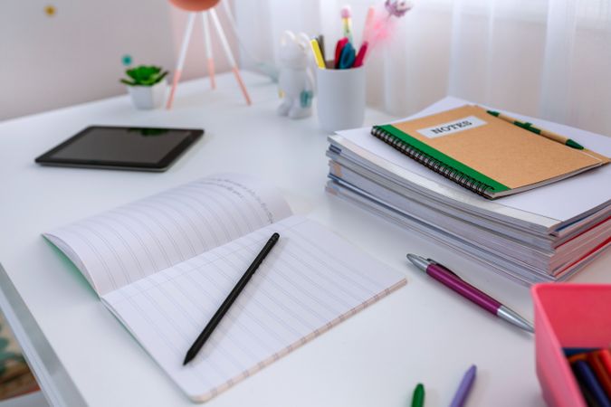 Desk in girl's bedroom decorated in pastel colors