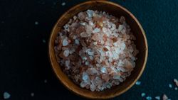 Top view close up of pink salt in bowl