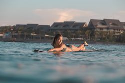 woman on surf board floating on water