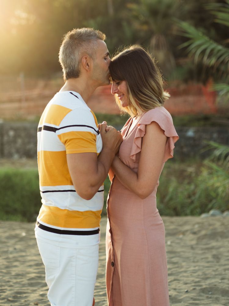 Happy couple looking at each other on beach