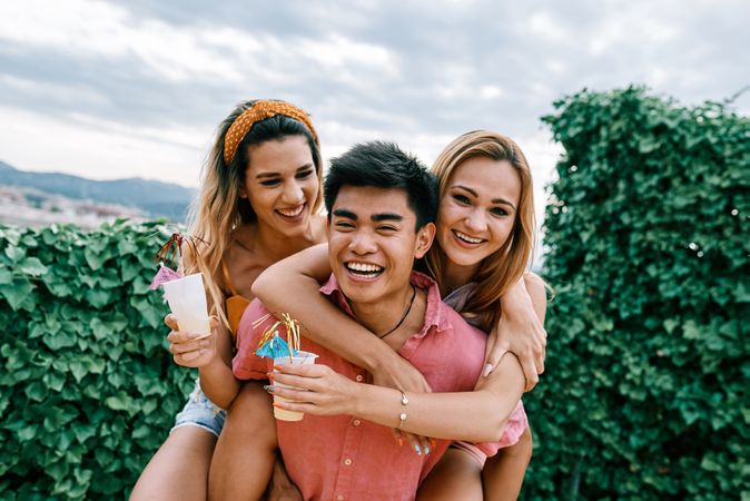 Happy man carrying his girlfriend on the back and having a good time