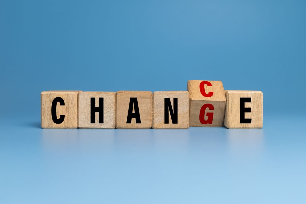 flip wooden blocks with change and chance words isolated on blue background