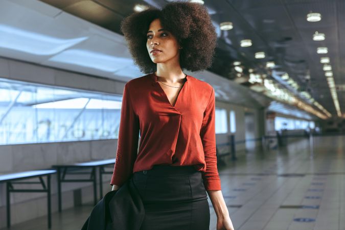 Black woman standing at airport terminal