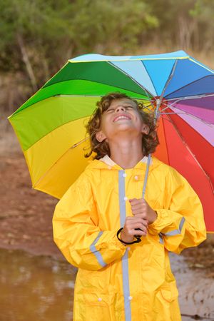 Smiling boy enjoying rainy day