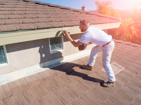 Professional Painter Using A Brush to Paint House Fascia