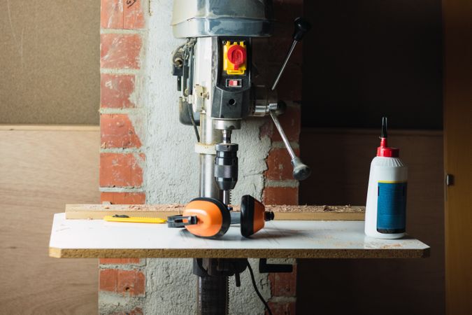 Modern drilling machine in grunge carpentry