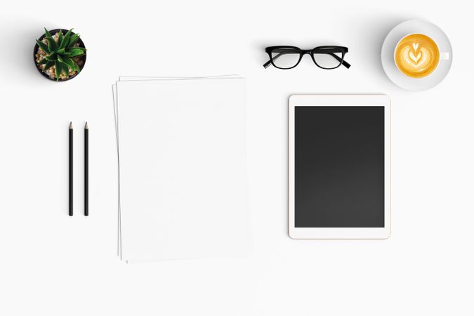 Modern workspace with coffee cup, smartphone, paper, notebook, tablet copy space