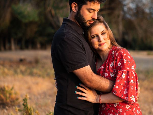 Young happy couple embracing in beautiful garden