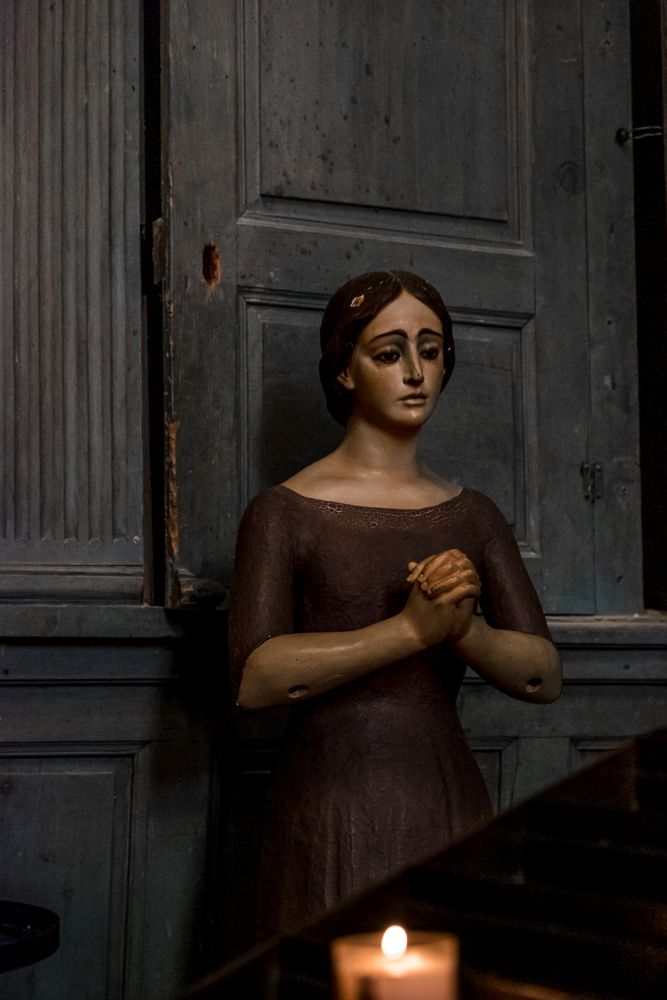 Religious statue with candle