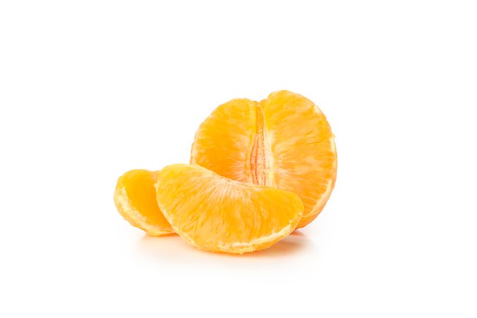 Half of mandarin and pieces isolated on light background
