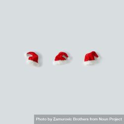 Santa hats in a row on light background 5R3E24
