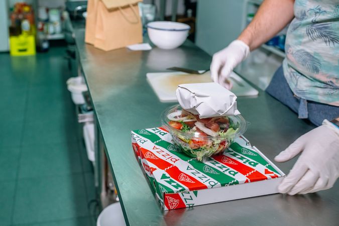 Unrecognizable chef with a food delivery order ready to go