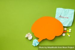 Orange paper cut out of brain on green background, copy space 5Qp190