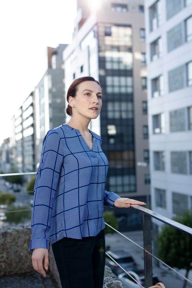 Smiling businesswoman standing on balcony