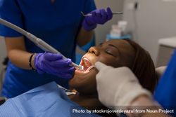 A Black woman patient in dental cleaning 48BBVq