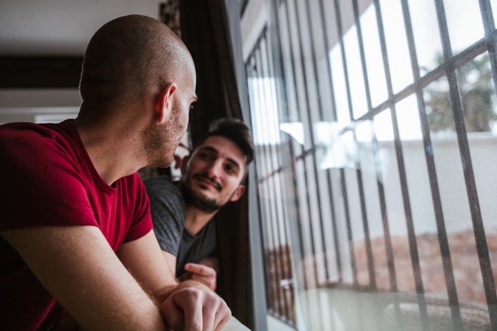 young gay couple in the window