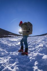 Tourist gazing at breathtaking snowy mountain slope