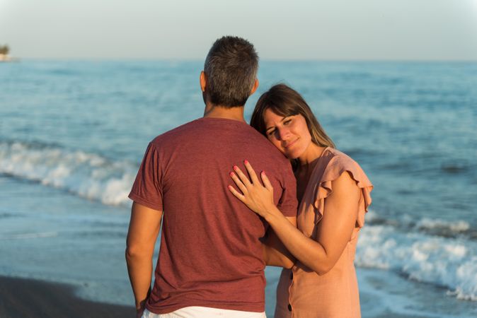 Adult couple embracing near sea