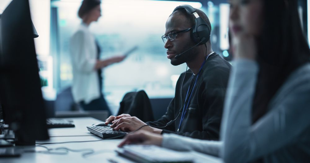 Black Man Wearing Glasses and Headphones with a Microphone