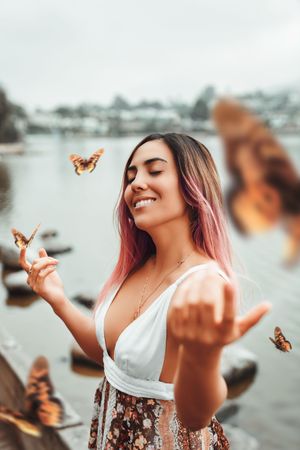 Smiling woman with brown butterflies flying over