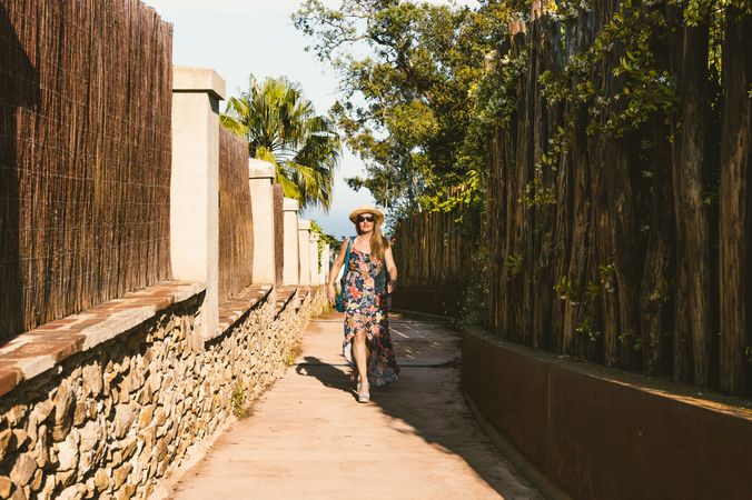 Woman walking in narrow path