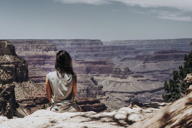 Tourist gazing while standing on edge of picturesque canyon