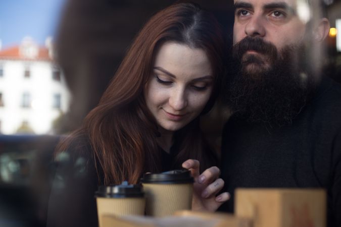 Couple pictured through cafe window