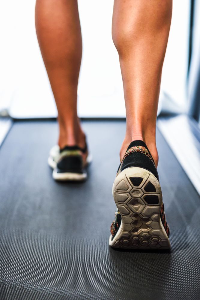Legs of male on running machine
