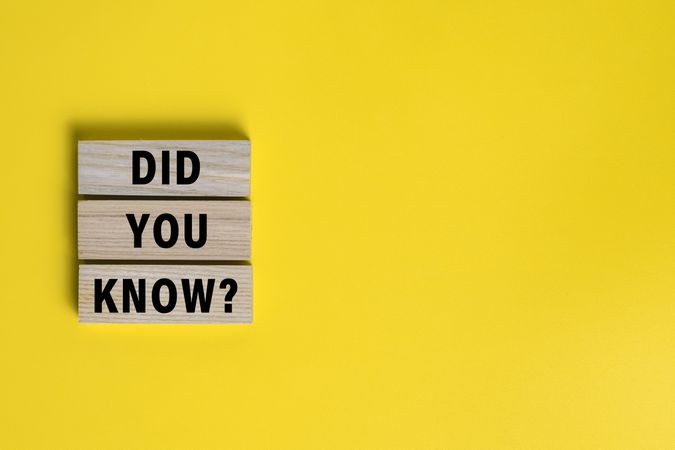 did you know words on wooden blocks isolated on yellow background. copy space