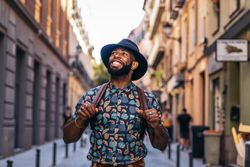 Stylish Black man walking on the city street