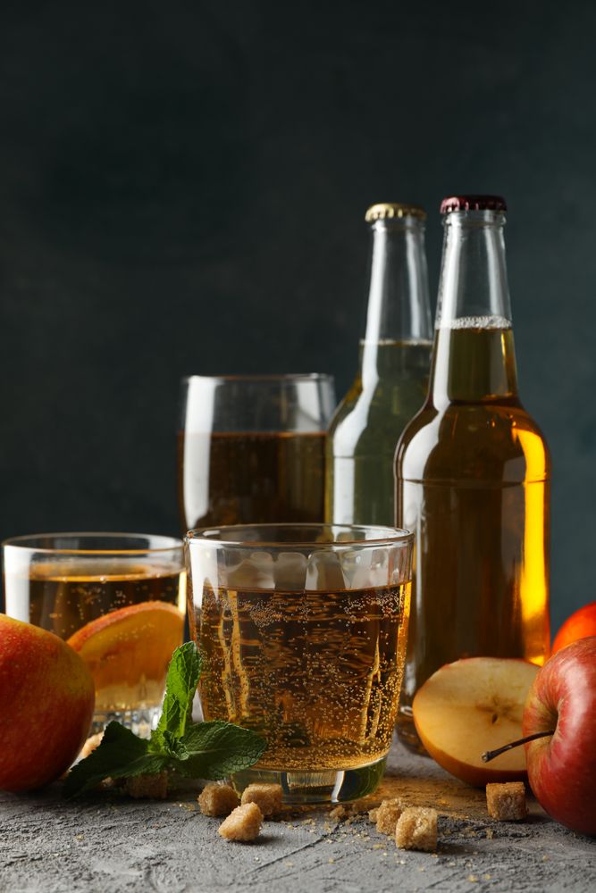 Composition with cider, sugar and apples on gray background
