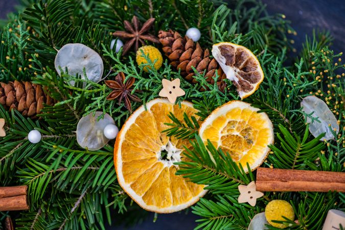 Close up of Christmas wreath with star anise, cinnamon sticks and dried orange slices