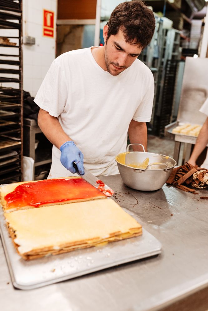 Baker with freshly glazed cakes