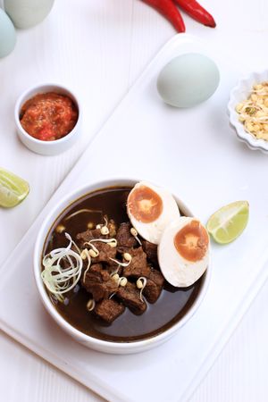 Top view of Bowl of Rawon, Indonesian Beef Soup Dish