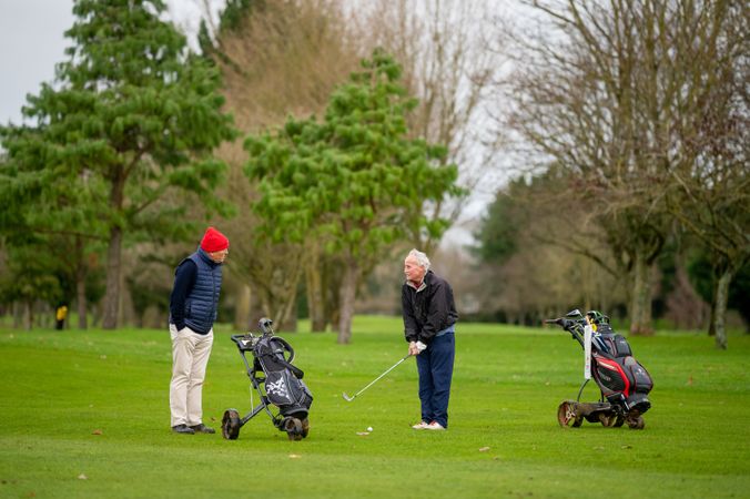 Mature male friends playing golf