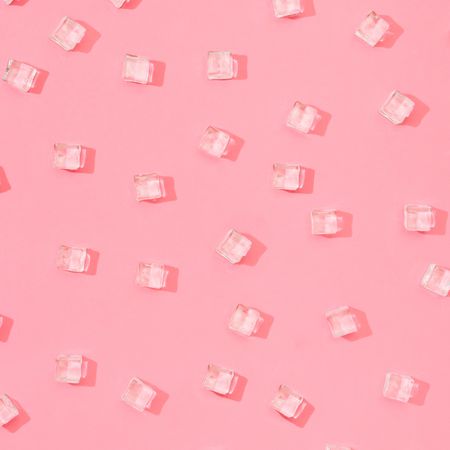 Ice cubes pattern on pastel pink background
