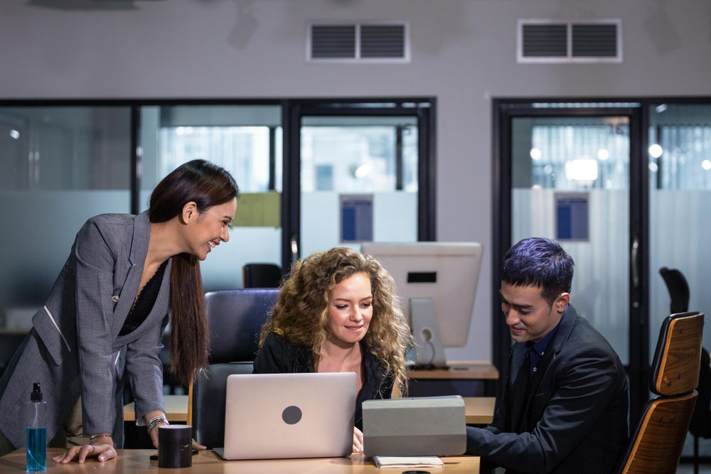Corporate team working with laptop and computer tablet at business office