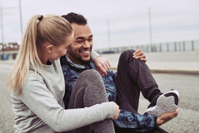 Affectionate woman with arm over her boyfriends neck