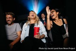 Young women and men watching comedy movie in cinema 5n6DD5
