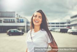 Radiant brunette woman smiling in parking lot 0LQdX5